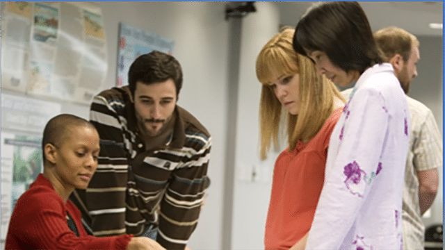 students and teacher discussing materials